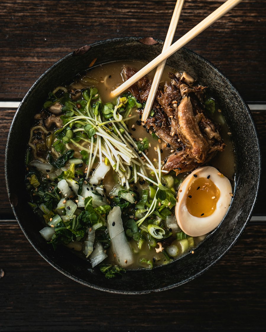 Kuro Mayu en bol negro con brotes, cebolleta y chashu